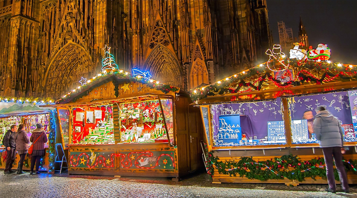 festively decorated Christmas market stalls outside Strasbourg Cathedral